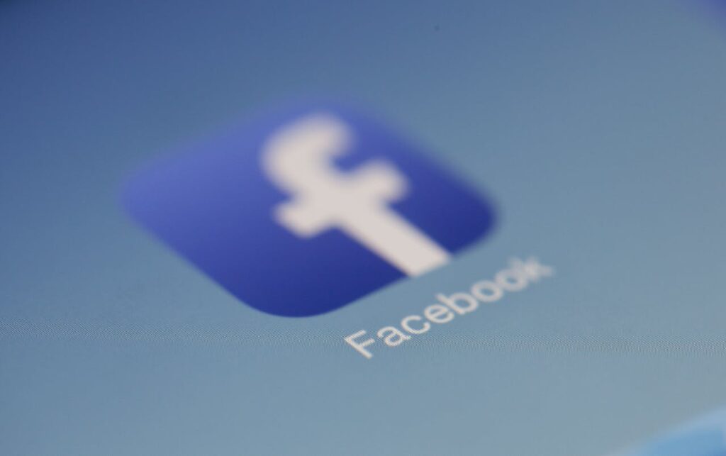 Close-up view of the Facebook app logo on a digital screen with blurred background.